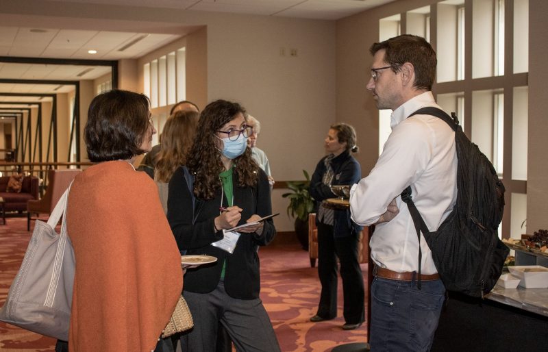 Three participants mingle at a reception following the Whole Health Launch event held in March 2023. 
